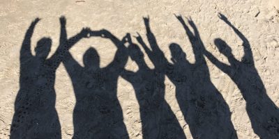 Gruppenbild am Strand mit Jugendlichen und Erziehern